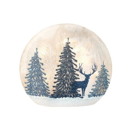 Lanterne avec cerf et sapins enneigés