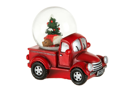 Camion rouge avec boule à neige