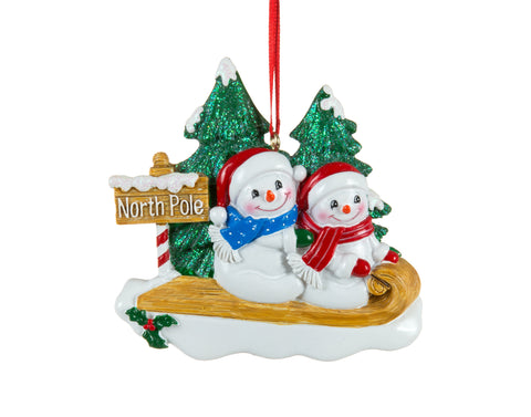 Ornement famille de bonshommes de neige sur luge