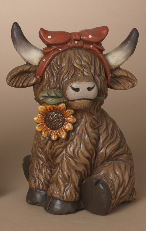 Vache Highland décorative avec bandeau rouge et tournesol
