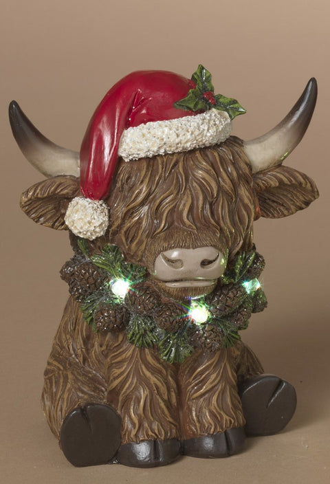 Vache Highland de Noël en résine avec guirlande lumineuse