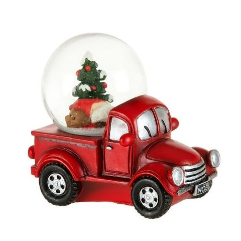 Camion rouge avec boule à neige