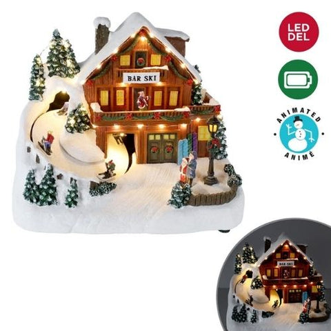 Village de Noël lumineux avec skieur animé