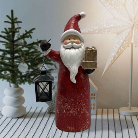 Père Noël avec cadeaux et lanterne