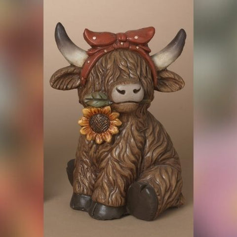 Vache Highland décorative avec bandeau rouge et tournesol